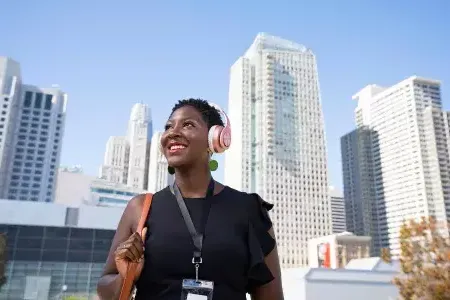 A woman wearing headphones walks through 威尼斯人官网平台app的 SoMa neighborhood.